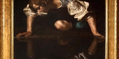 Caravaggio's Narcissus painting in a gilded frame